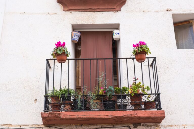 classic-balcony-with-flowers-and-green-plants-2023-11-27-05-35-44-utc