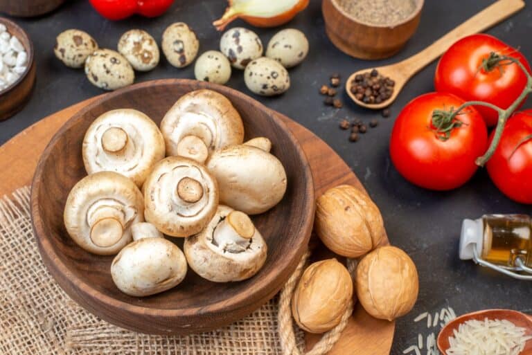 bottom-view-mushrooms-in-bowl-walnuts-on-wood-boar-2023-11-27-04-59-17-utc